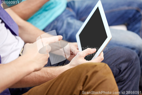 Image of close up of male hands with tablet pc at home