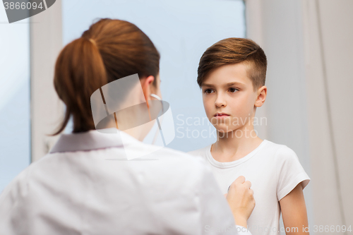 Image of doctor with stethoscope listening to child