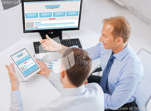 Image of businessmen with web design on tablet pc computer