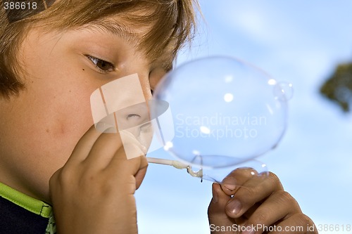 Image of boy blowing bubbles