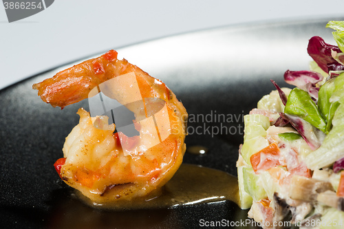 Image of perfect dish with shrimps on a black plate. seafood