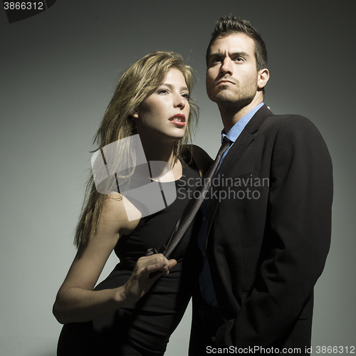 Image of elegant fashionable couple in black suit and dress