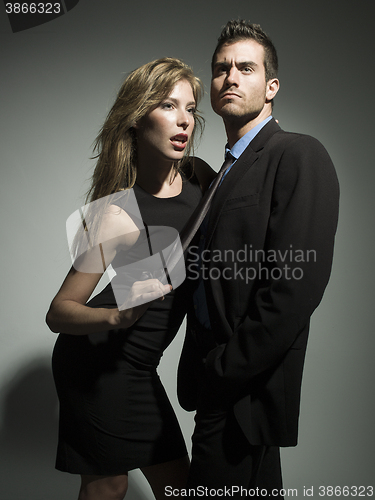 Image of elegant fashionable couple in black suit and dress