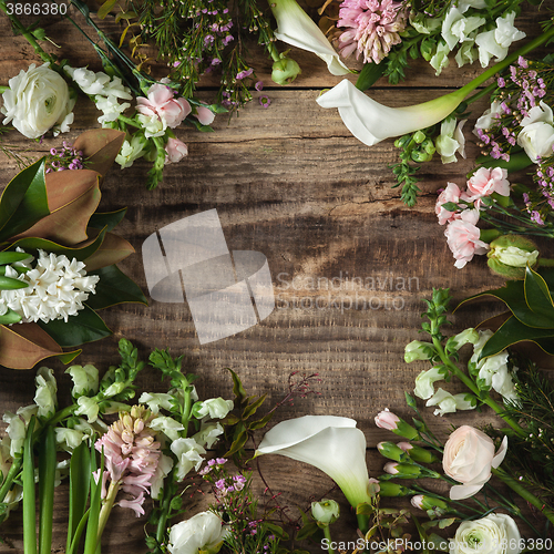 Image of Frame from flowers on wooden background