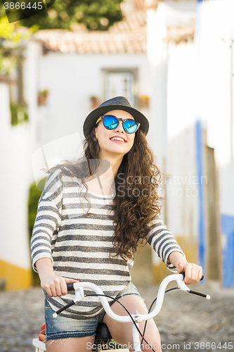 Image of Happy girl riding a bicycle 