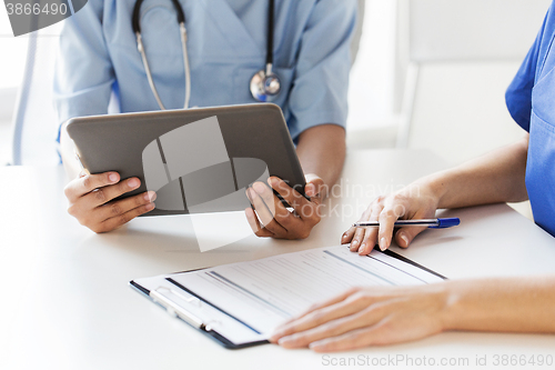 Image of close up of doctors with tablet pc at hospital