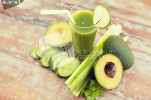 Image of close up of fresh green juice glass and vegetables