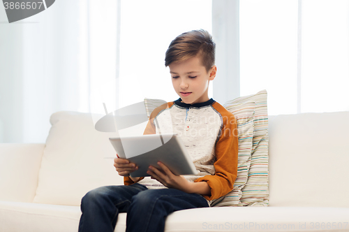 Image of boy with tablet computer at home