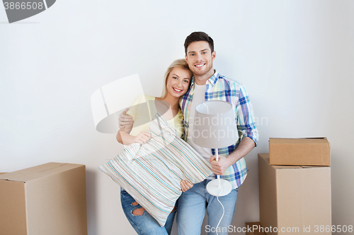 Image of happy couple with stuff moving to new home