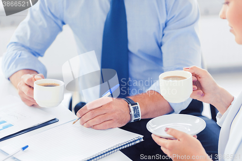 Image of man and woman discussing something in office