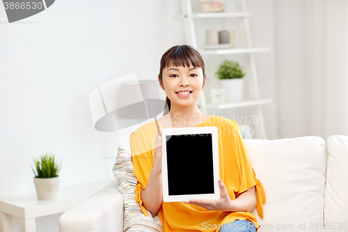 Image of happy young asian woman with tablet pc at home