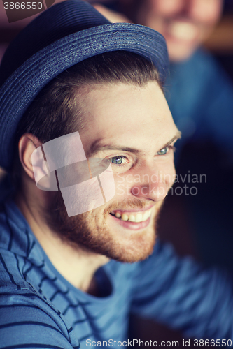 Image of happy young man in hipster hat