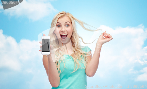 Image of happy young woman or teenage girl with smartphone