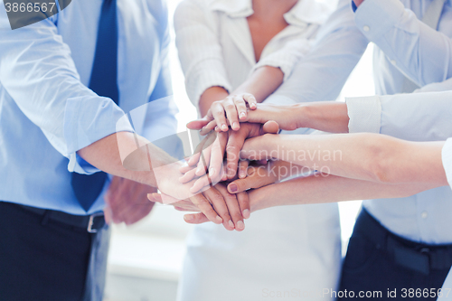 Image of business team celebrating victory in office