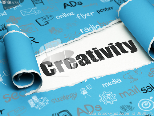 Image of Marketing concept: black text Creativity under the piece of  torn paper