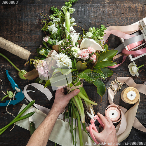 Image of The florist desktop with working tools and ribbons