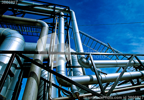 Image of Industrial zone, Steel pipelines and valves against blue sky