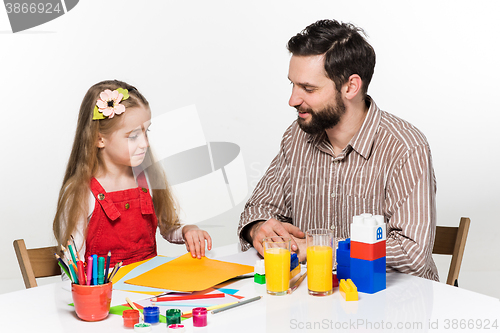 Image of The daughter and father drawing together