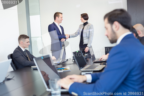 Image of Business people shaking hands.