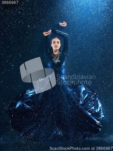 Image of The young beautiful modern dancer dancing under water drops