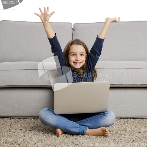 Image of Little girl working with a laptop