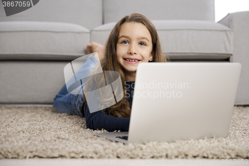 Image of Little girl working with a laptop