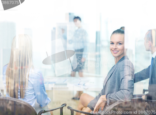 Image of businesswoman with team showing in office