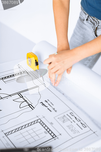 Image of architect drawing on blueprint