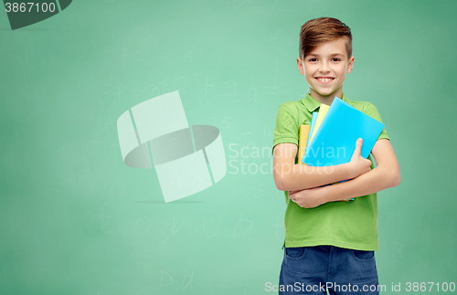 Image of happy student boy with folders and notebooks