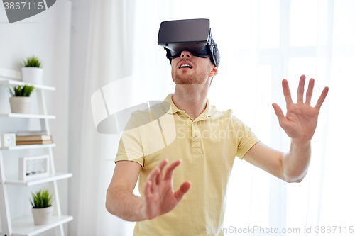 Image of young man in virtual reality headset or 3d glasses