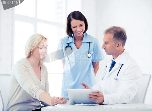 Image of doctor and nurse with patient in hospital