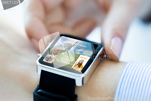 Image of close up of hands with application on smartwatch