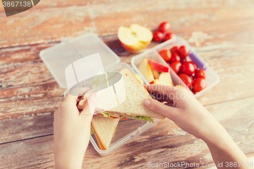 Image of close up of woman with food in plastic container