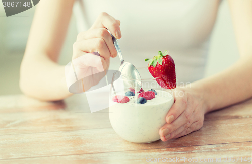 Image of close up of woman hands with yogurt and berries