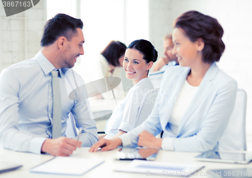 Image of business team discussing something in office