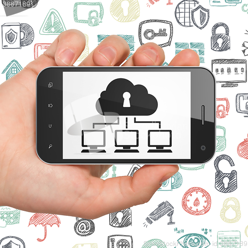 Image of Protection concept: Hand Holding Smartphone with Cloud Network on display