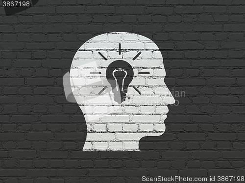 Image of Business concept: Head With Light Bulb on wall background