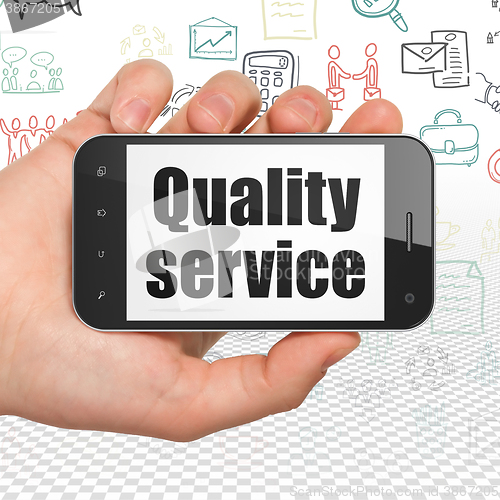 Image of Finance concept: Hand Holding Smartphone with Quality Service on display