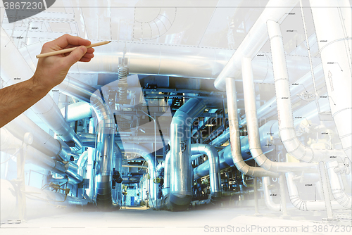 Image of man\'s hand draws a design of factory combined with photo of mode