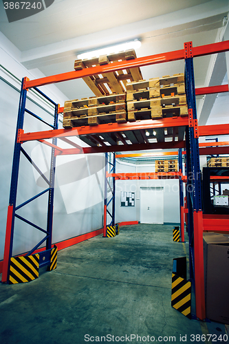 Image of Shelves and racks with pallets in distribution warehouse interio