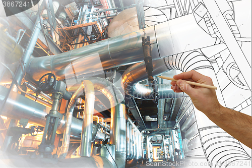 Image of man\'s hand draws a design of factory combined with photo of mode