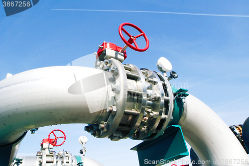 Image of Industrial zone, Steel pipelines and valves against blue sky