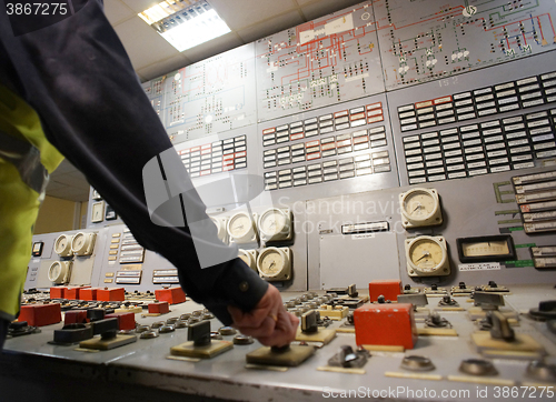 Image of Hand on the control panel of a power plant