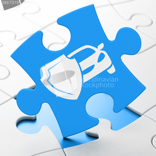 Image of Insurance concept: Car And Shield on puzzle background