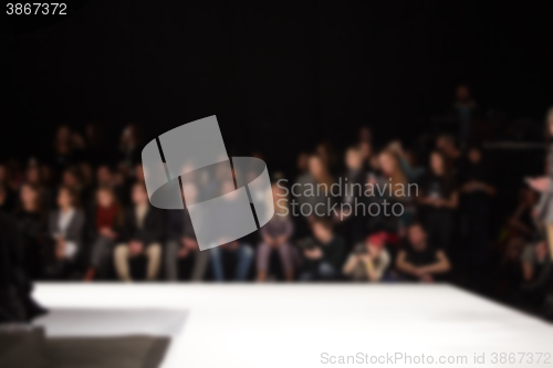 Image of blurred image of group audience at fashion show stage