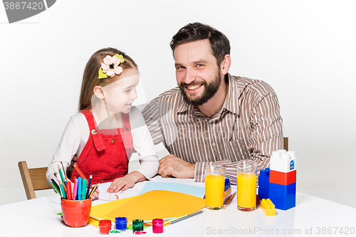 Image of The daughter and father drawing together