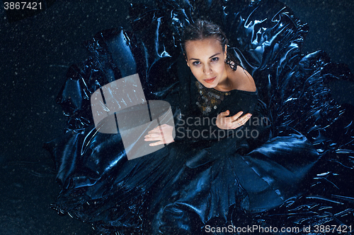 Image of The young beautiful modern dancer posing under water drops