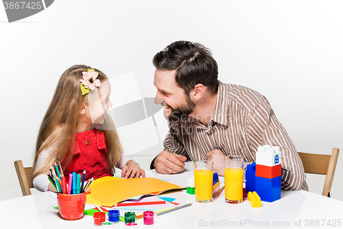 Image of The daughter and father drawing together