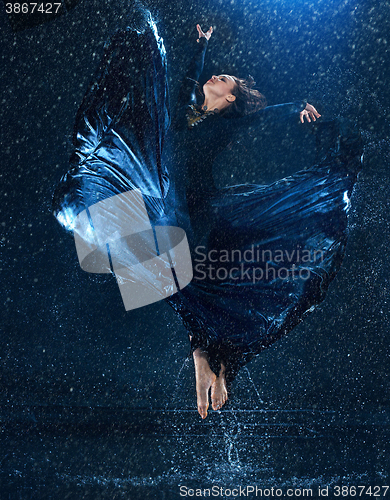 Image of The young beautiful modern dancer dancing under water drops