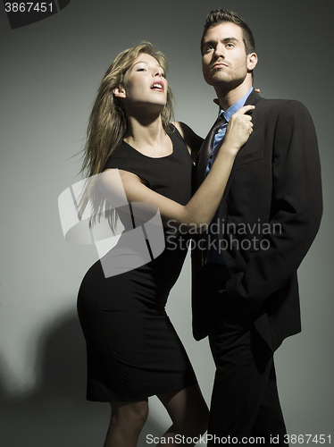 Image of elegant fashionable couple in black suit and dress